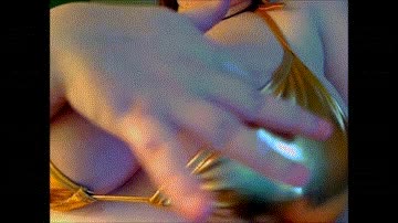 Still from clip titled Gold Bikini Mindfuck